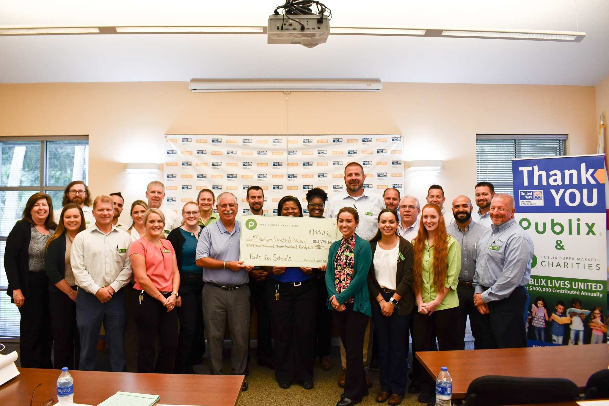 Publix Employees holding check